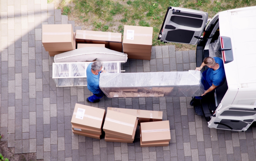 Packers loading household goods into a moving truck