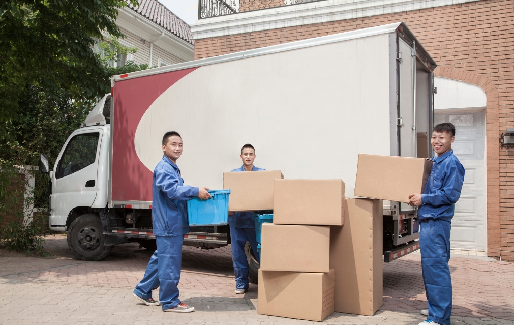 Family preparing to move with packed boxes around